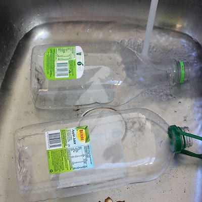 Soaking plastic bottles in sink to remove labels